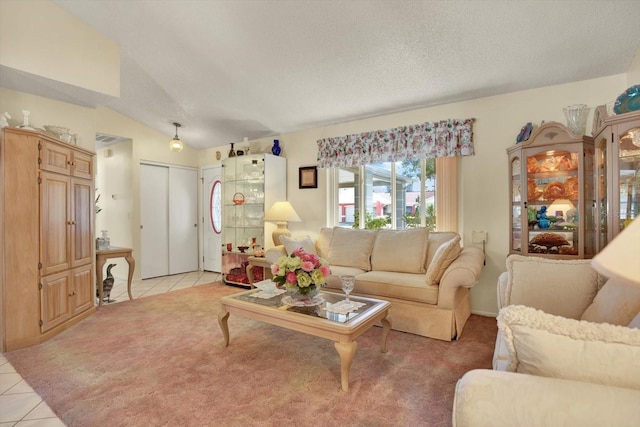 tiled living room featuring lofted ceiling and a textured ceiling