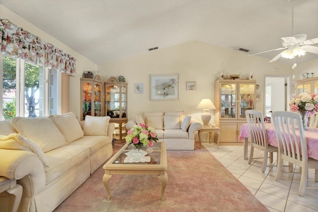 tiled living room featuring ceiling fan and lofted ceiling