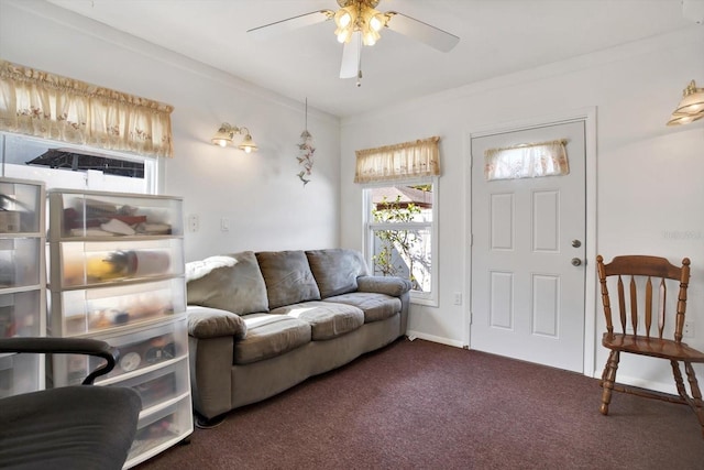 living room featuring dark colored carpet, crown molding, and ceiling fan