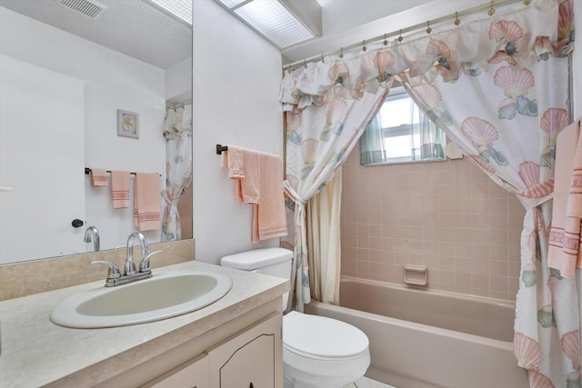 full bathroom with vanity, shower / tub combo, and toilet