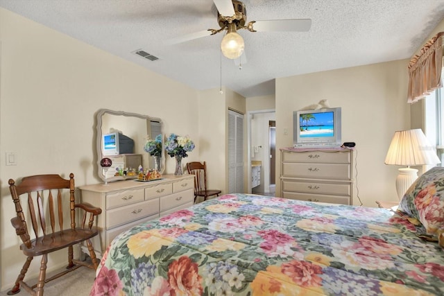 bedroom with ceiling fan, light colored carpet, a textured ceiling, and a closet