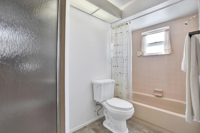 bathroom with shower / tub combo with curtain, tile patterned floors, and toilet