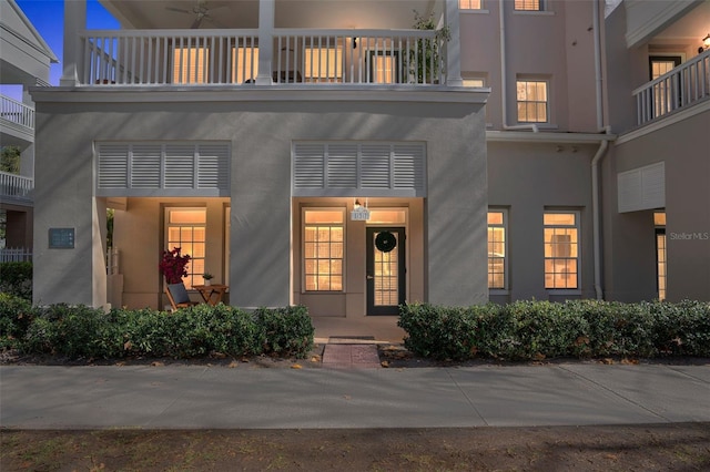 view of exterior entry featuring ceiling fan