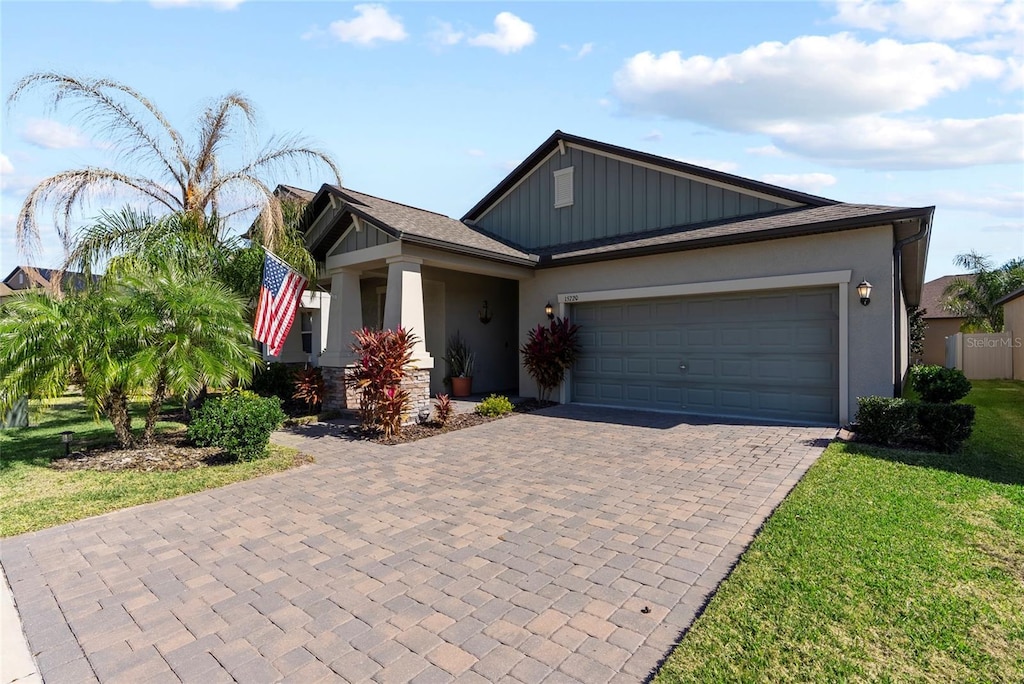 view of front of home with a garage and a front yard