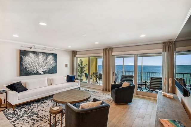 living room with a water view, ornamental molding, and hardwood / wood-style flooring