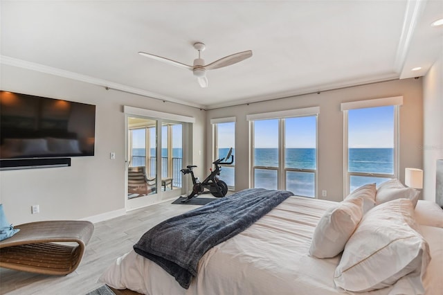 bedroom with multiple windows, ornamental molding, access to outside, a water view, and light hardwood / wood-style flooring