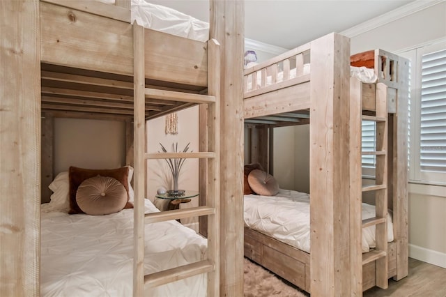 bedroom with hardwood / wood-style floors and ornamental molding