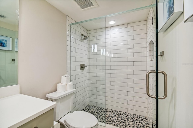 bathroom with vanity, toilet, and walk in shower