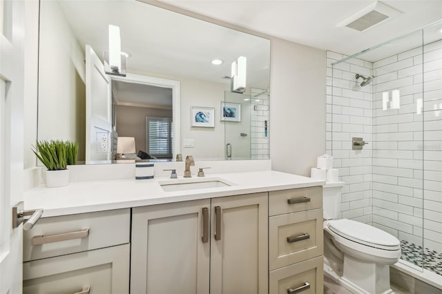 bathroom with vanity, an enclosed shower, and toilet