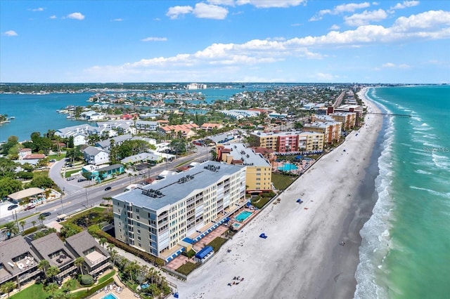 bird's eye view with a water view and a beach view