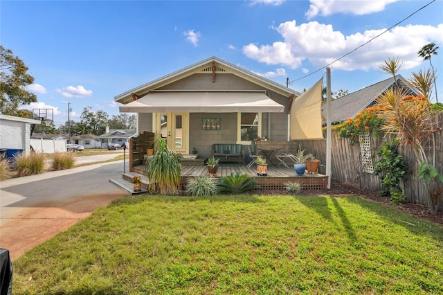 bungalow with a porch and a front lawn