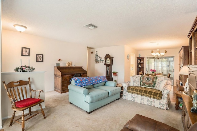 carpeted living room with a chandelier and a textured ceiling