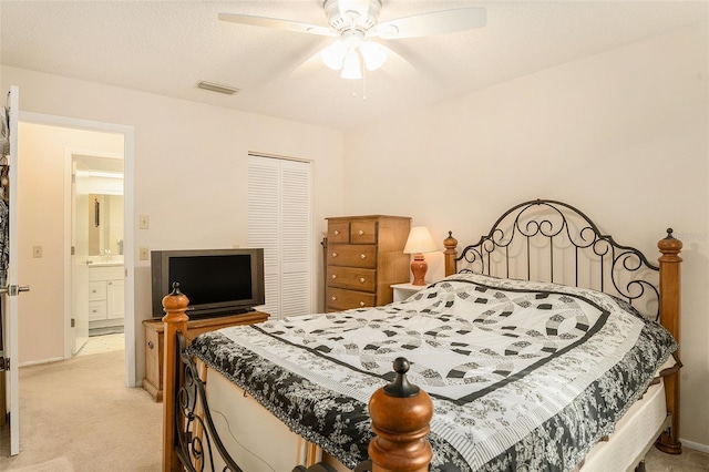 carpeted bedroom featuring a textured ceiling, ceiling fan, and a closet