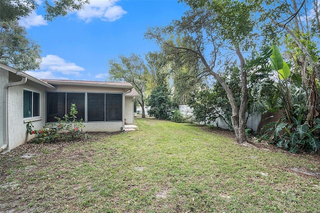 view of yard featuring a sunroom