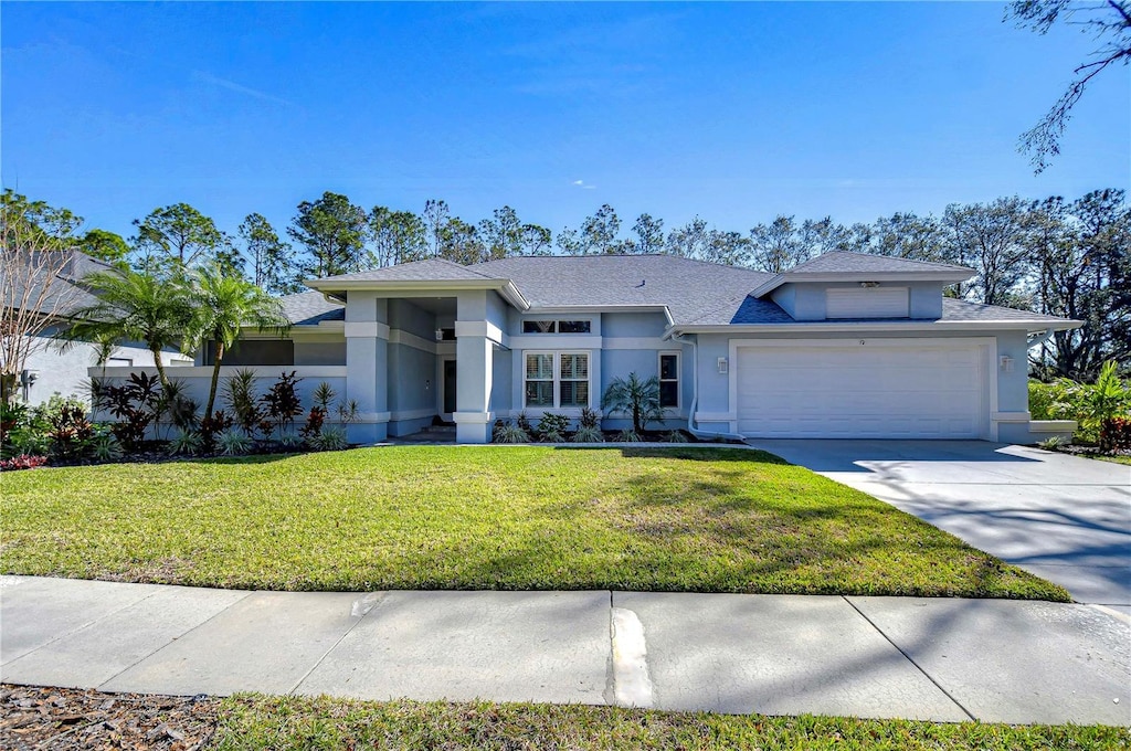 view of front of house with a garage and a front yard