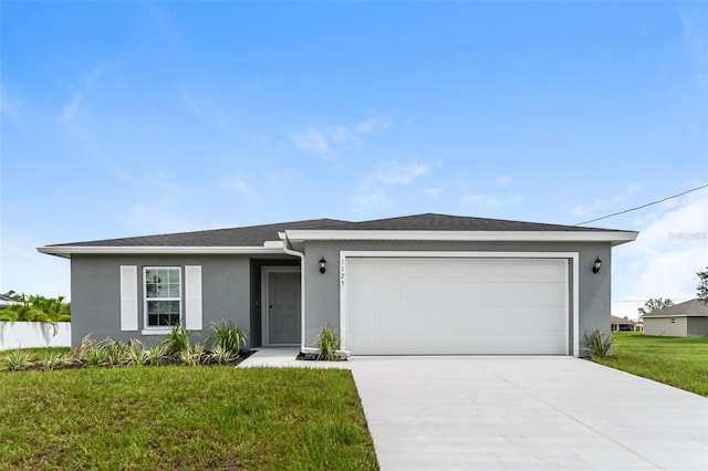 view of front of house featuring a garage and a front lawn