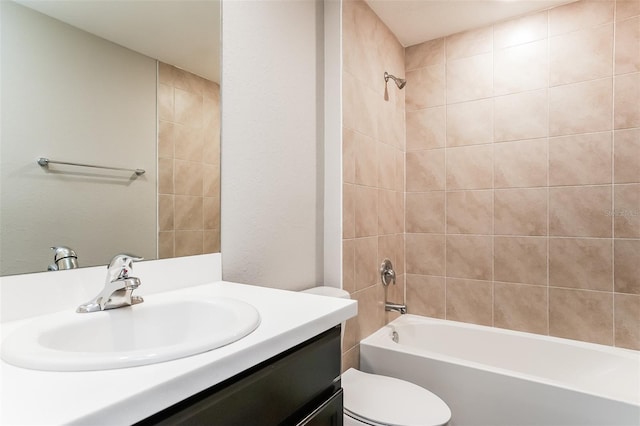 full bathroom with vanity, toilet, and tiled shower / bath combo