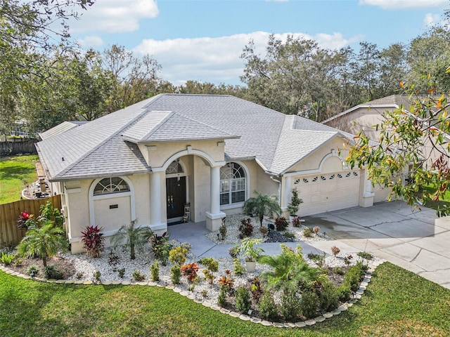 ranch-style house featuring a garage and a front yard