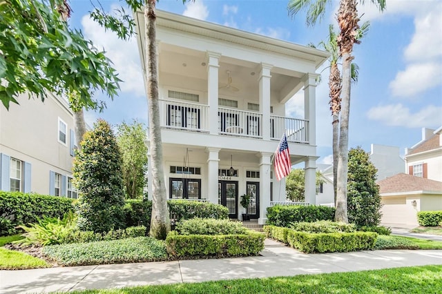 greek revival inspired property with a balcony and a porch