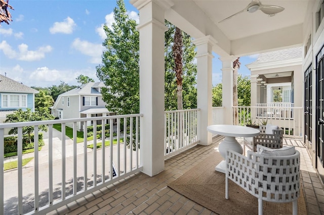 balcony with ceiling fan and a porch