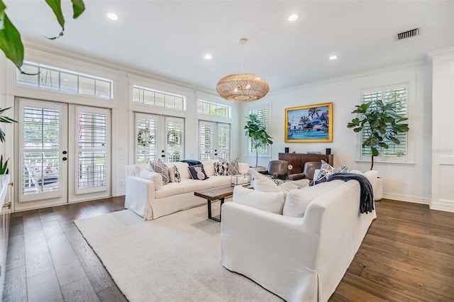 living room featuring french doors, ornamental molding, dark wood-type flooring, and plenty of natural light