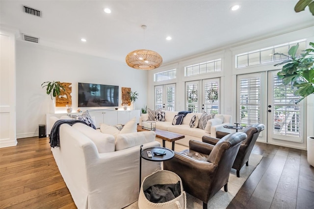 living room featuring french doors, a healthy amount of sunlight, and hardwood / wood-style flooring