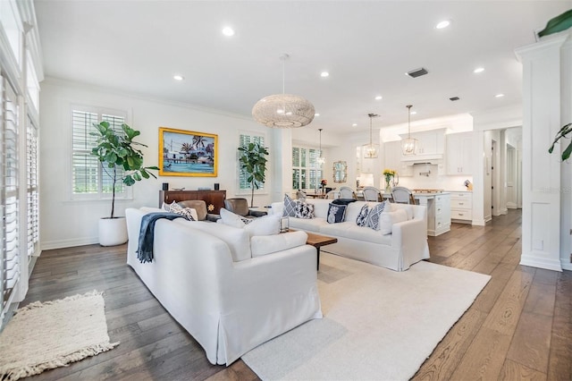 living room featuring wood-type flooring and ornamental molding