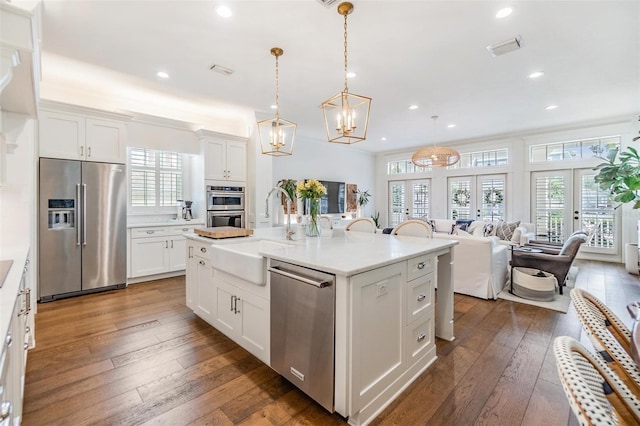 kitchen featuring french doors, stainless steel appliances, sink, and white cabinets