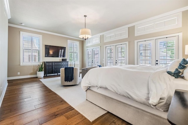 bedroom featuring crown molding, dark wood-type flooring, access to outside, and french doors