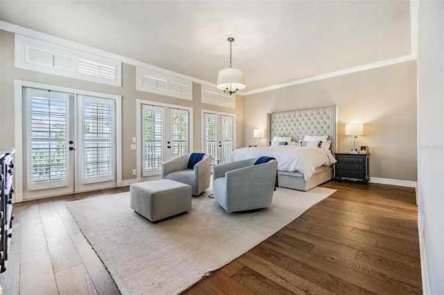 bedroom featuring an inviting chandelier, access to exterior, ornamental molding, dark hardwood / wood-style flooring, and french doors