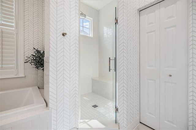 bathroom featuring shower with separate bathtub