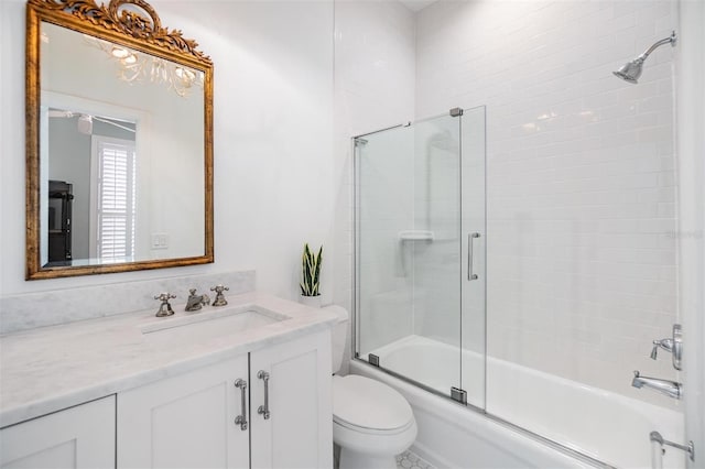 full bathroom with toilet, vanity, and bath / shower combo with glass door