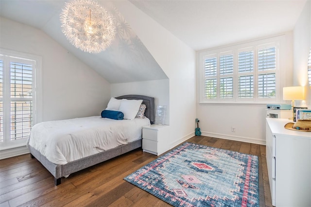 bedroom featuring dark wood-type flooring, lofted ceiling, and multiple windows