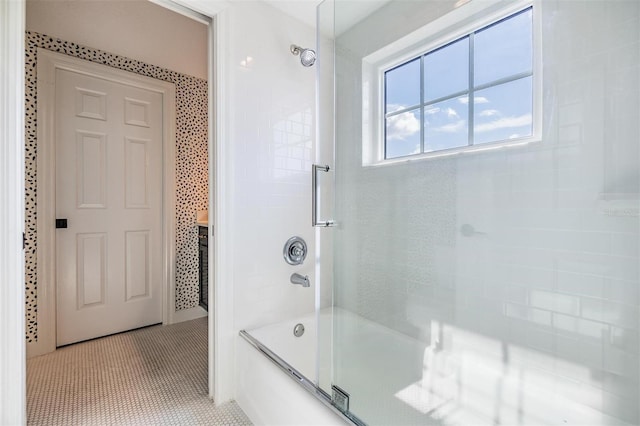 bathroom featuring tile patterned floors and combined bath / shower with glass door