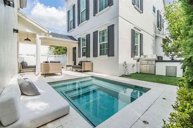 view of swimming pool with area for grilling, exterior kitchen, and a patio area