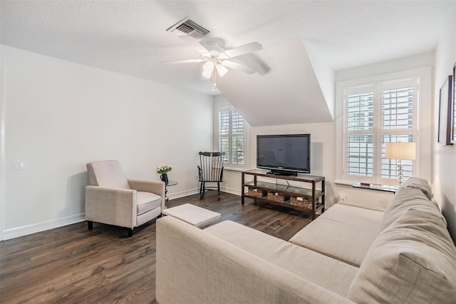 living room with lofted ceiling, dark hardwood / wood-style floors, and ceiling fan