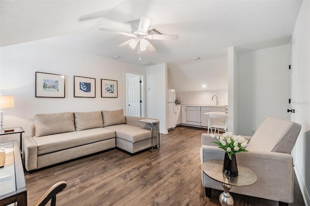 living room featuring ceiling fan, dark hardwood / wood-style floors, and sink