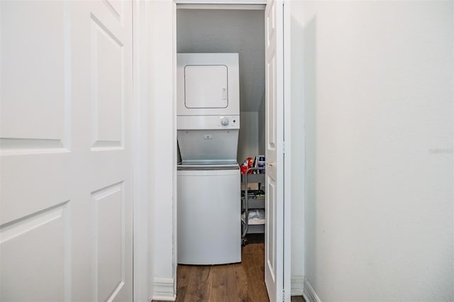 laundry area featuring stacked washer / dryer and wood-type flooring