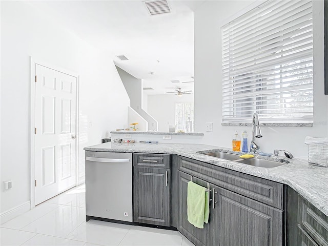 kitchen with sink, light stone counters, stainless steel dishwasher, kitchen peninsula, and ceiling fan