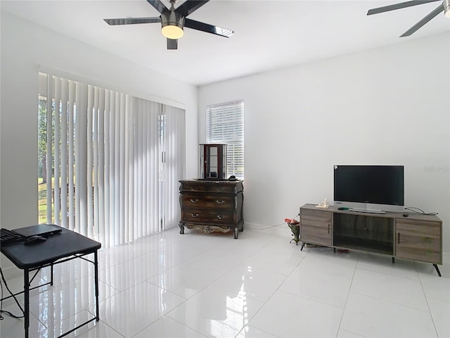 interior space featuring multiple windows, light tile patterned flooring, and ceiling fan