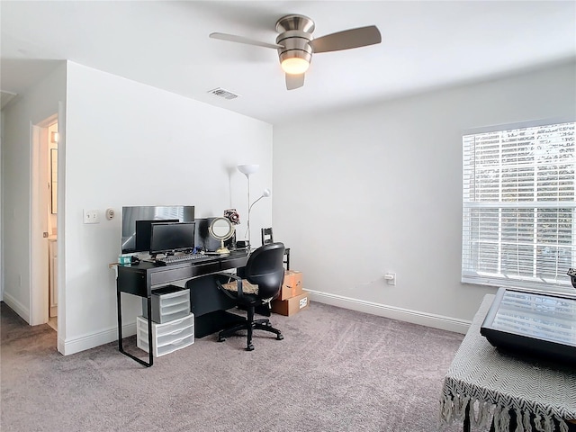 carpeted home office featuring ceiling fan