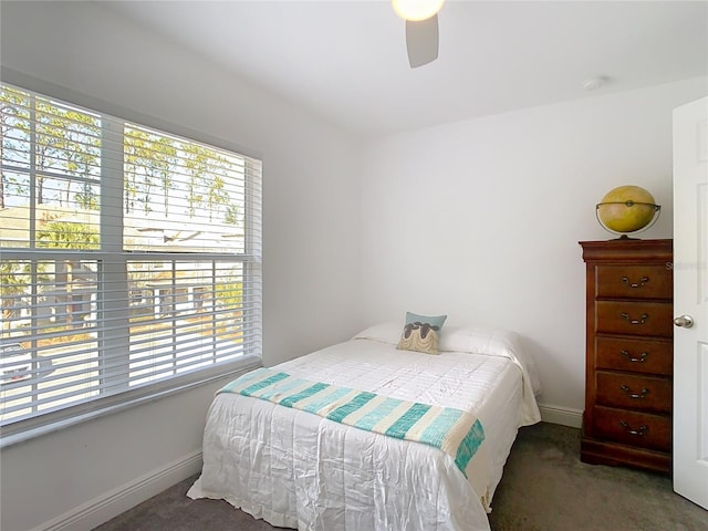 bedroom with ceiling fan and dark carpet