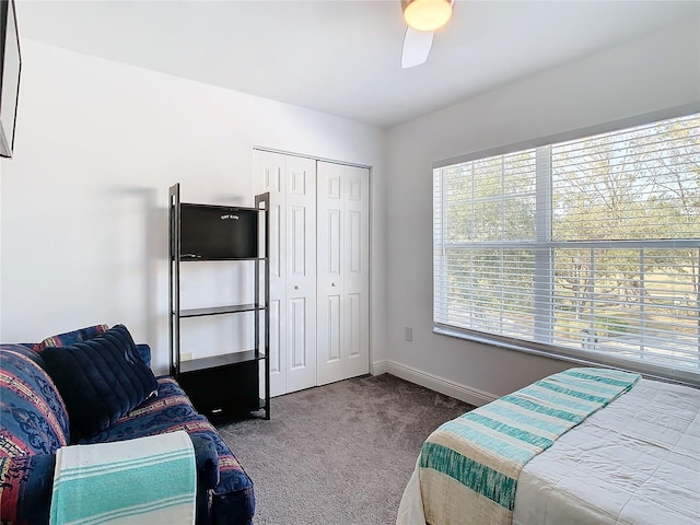 bedroom featuring carpet, ceiling fan, and a closet