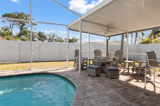 view of pool with ceiling fan, a patio area, and a fire pit