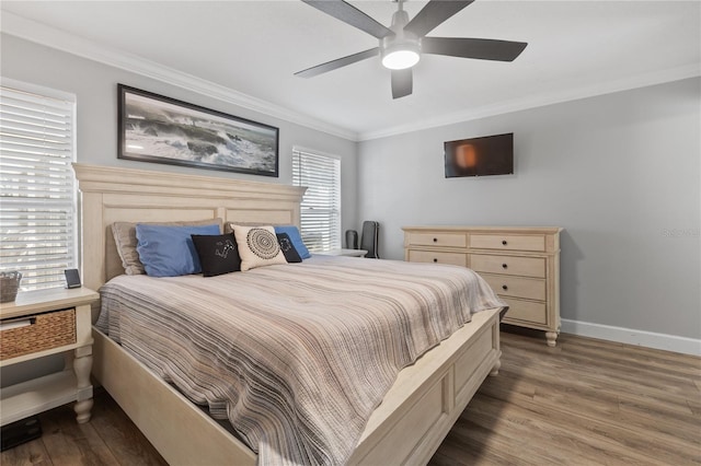 bedroom featuring hardwood / wood-style flooring, ornamental molding, and ceiling fan