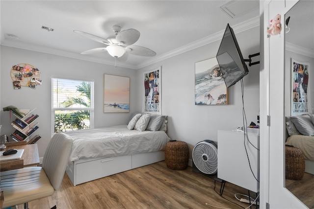 bedroom featuring crown molding, hardwood / wood-style flooring, and ceiling fan