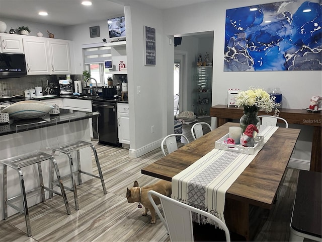 dining room with light hardwood / wood-style floors and sink