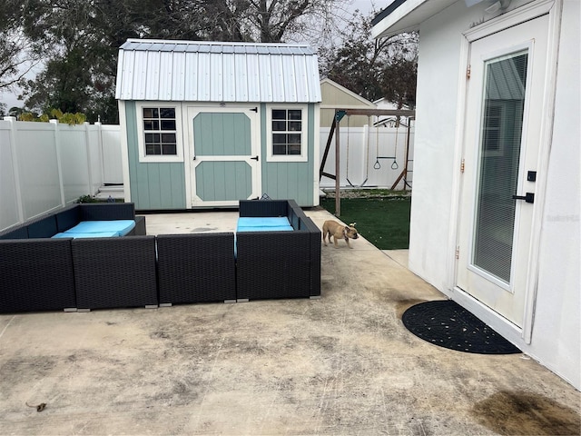 view of patio with an outdoor hangout area and a storage shed