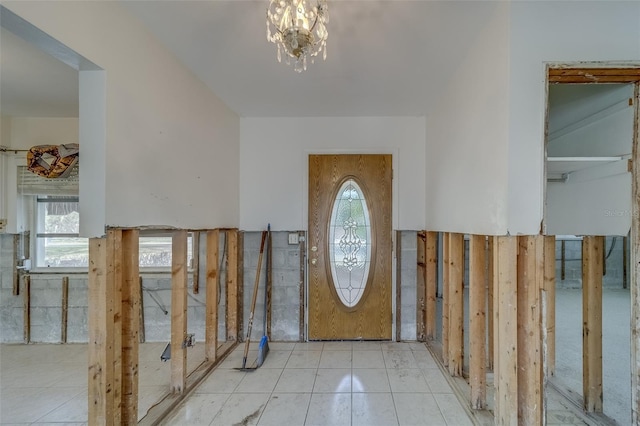 foyer with an inviting chandelier and light tile patterned floors