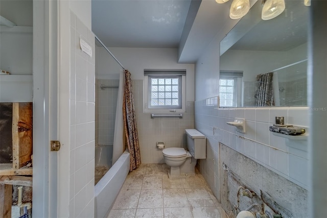 bathroom with shower / bath combo, tile walls, and toilet